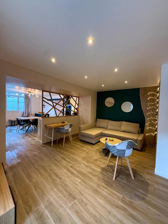 a living room with a couch and a table at Au Petit Casino in Vuillafans