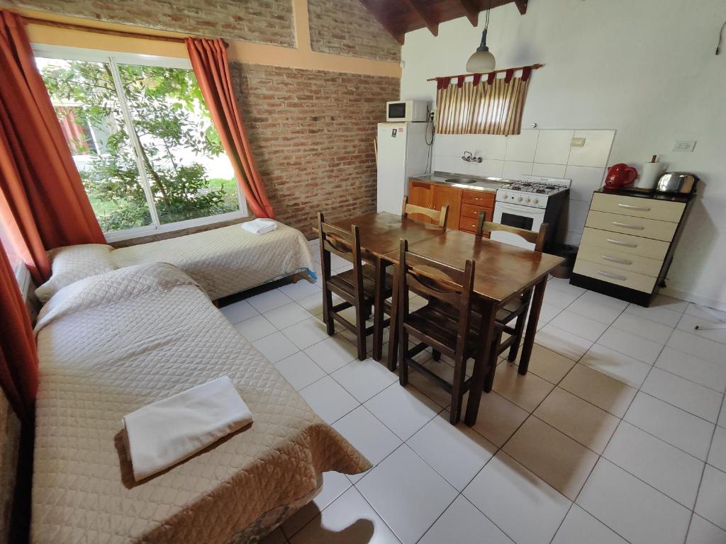 a living room with a table and a kitchen at La Posada del Mar in Miramar