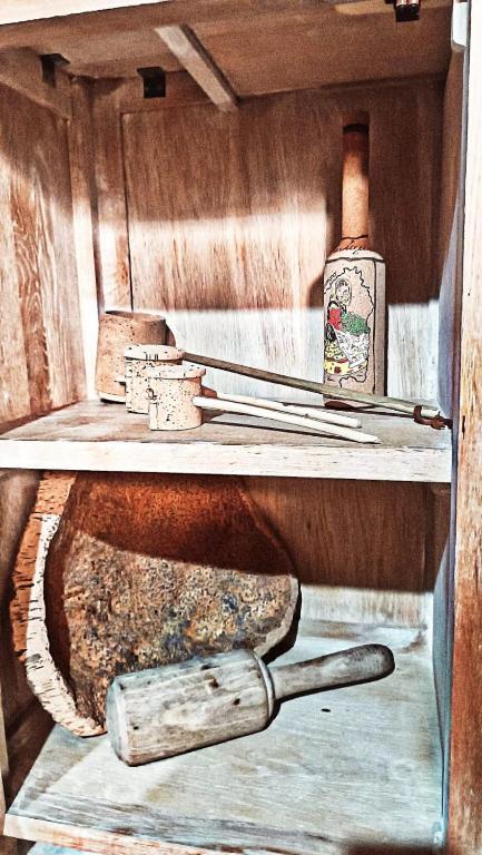 a painting of a cabinet with a bottle of alcohol at B&B Montiju in Ozieri