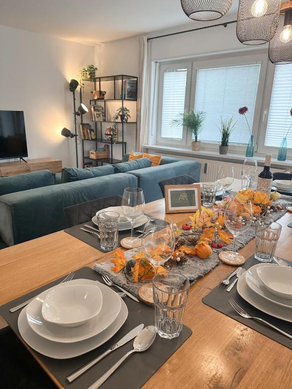 a dining room table with plates and glasses on it at Allgäu Retreat in Bad Wörishofen