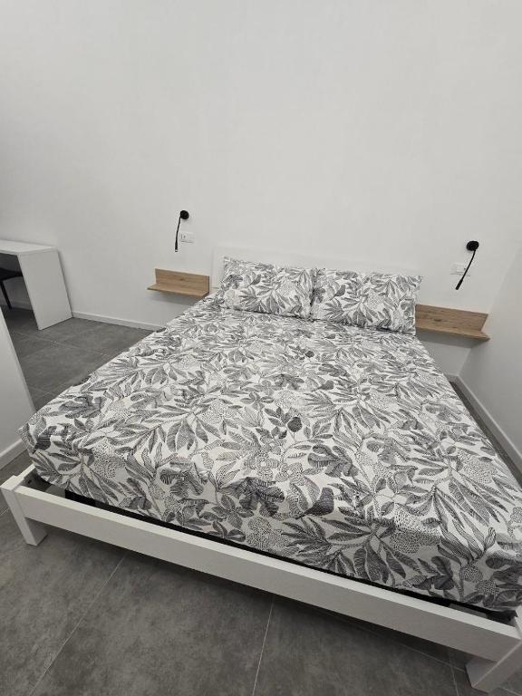 un letto in una camera bianca con lenzuola di DANITO Rooms 6 ad Ancona