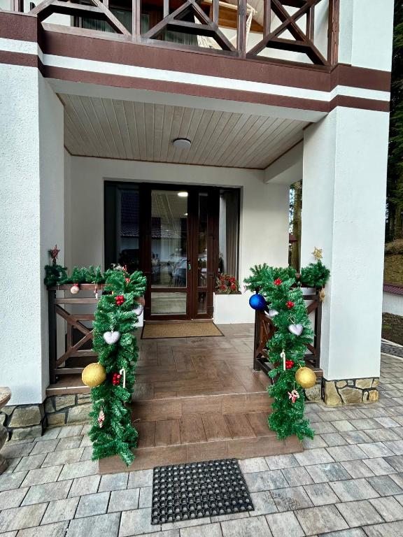 a building with christmas decorations on the front porch at Зелений ретрит in Skole