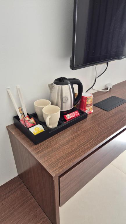 a table with a tv and a tea kettle on it at شاليه جوري حتا-4-Chalet Jory Hatta in Būbādī