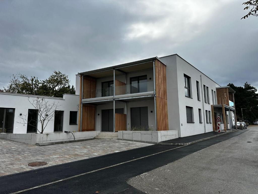 a large white building on the side of a street at Genuss Apartment in Purbach am Neusiedlersee