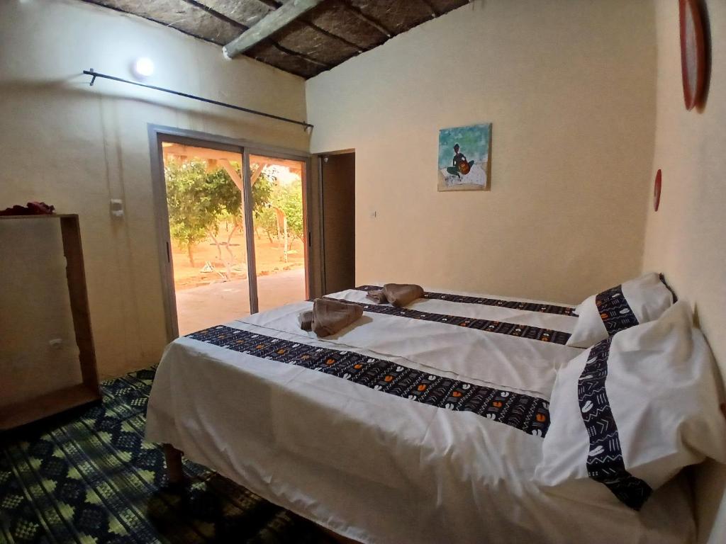 Ένα ή περισσότερα κρεβάτια σε δωμάτιο στο Lompoul Nature