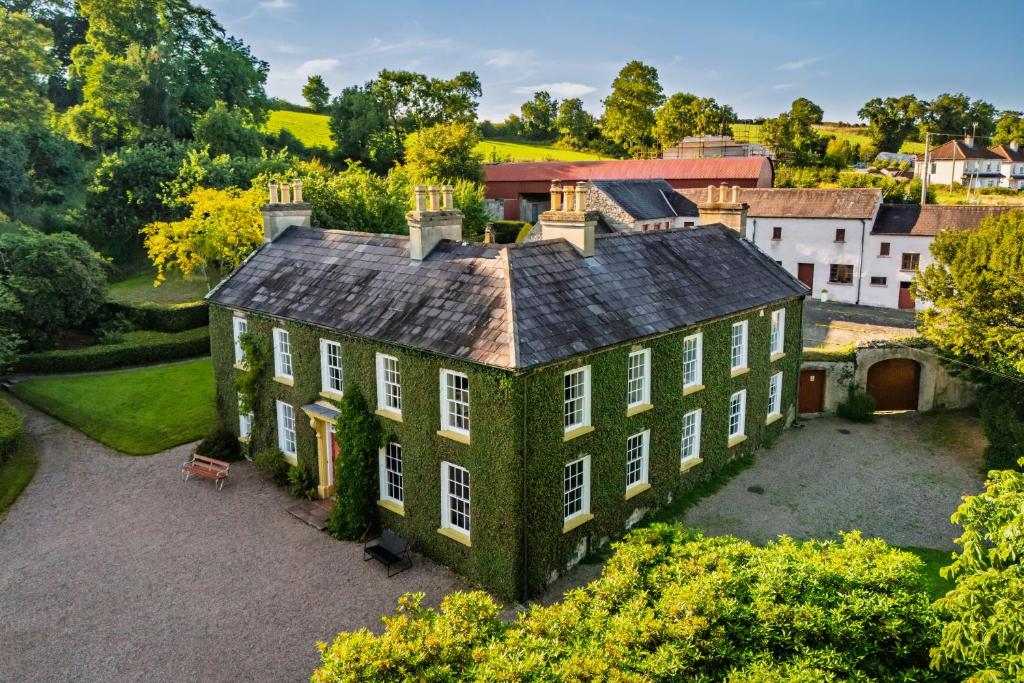 an aerial view of a large house with trees at Tullymurry House in Ardarragh