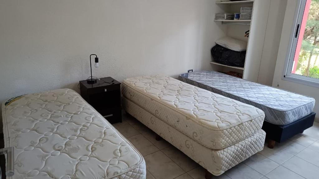 a room with two mattresses and two beds in it at Okin 22 La Reserva in Costa del Este
