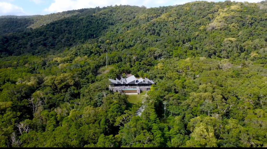 a house in the middle of a mountain at The Cassowary - Luxury Rainforest Retreat in Cassowary