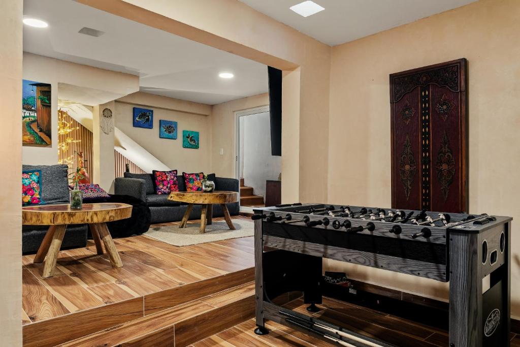 een woonkamer met een speeltafel in het midden bij Villa Lol Tun Breakfast and Beach Club Included in Isla Mujeres