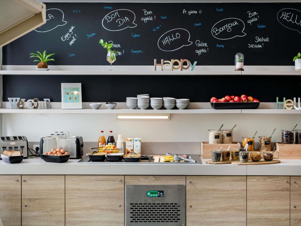 a kitchen with a counter with food on it at ibis Styles Strasbourg Stade de la Meinau in Strasbourg