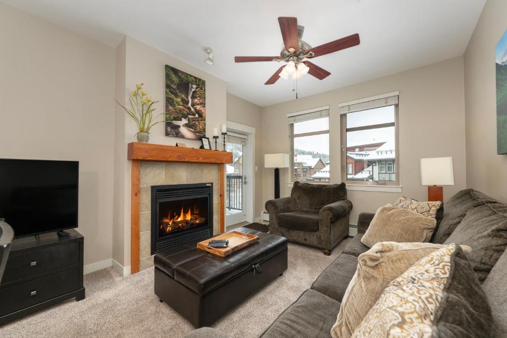a living room with a couch and a fireplace at Ski-In / Ski-Out 1 Bedroom Condo base of WP Resort in Winter Park