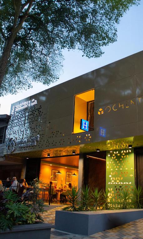 a building with a sign on the side of it at Habitat Ochentayuno in Medellín