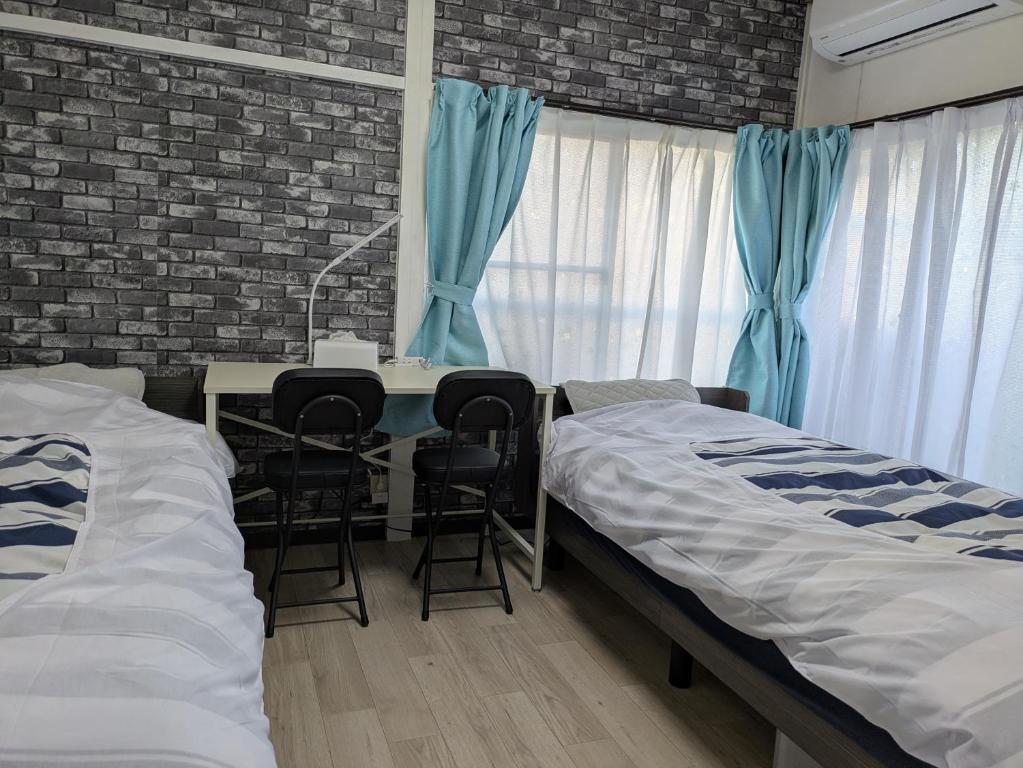 Ένα ή περισσότερα κρεβάτια σε δωμάτιο στο Manga House Awesome Shino