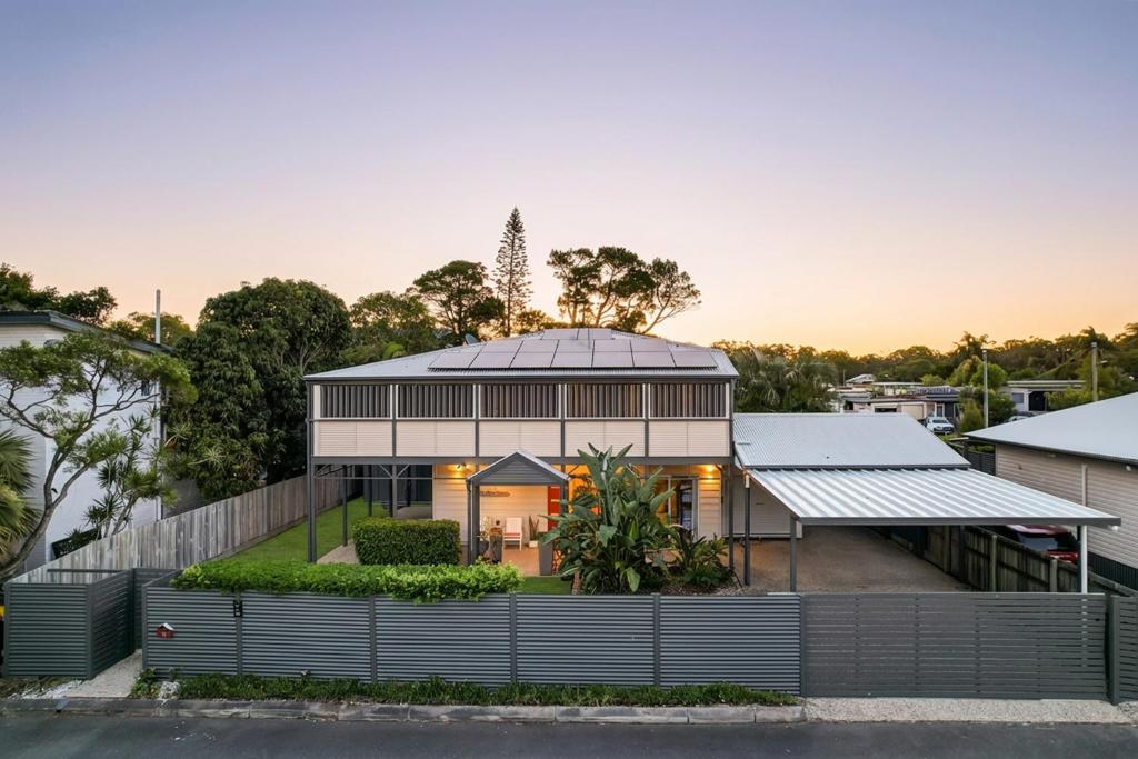 a house with a metal roof on a street at Cypress Sea Breeze in Woorim