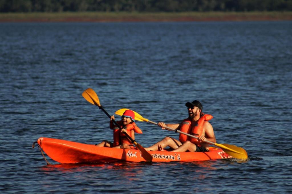 a man and a woman in a kayak on the water at Espacio Benignia in Puerto Libertad