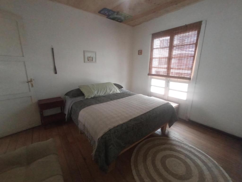a bedroom with a bed and a window at Monofacetas Plaza de Armas in La Serena