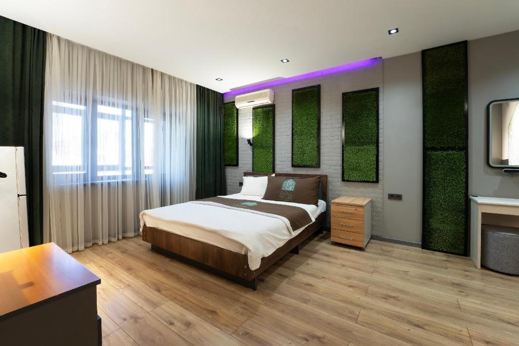 En eller flere senge i et værelse på Botanical House