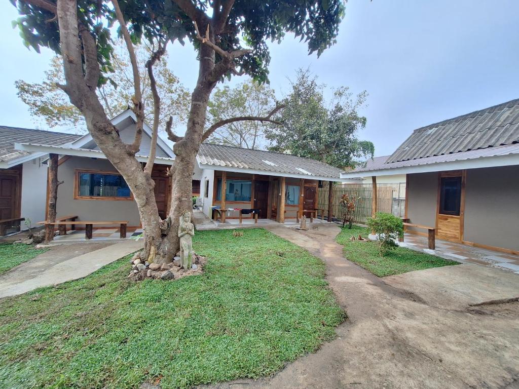 a house with a tree in the yard at So Good in Pai