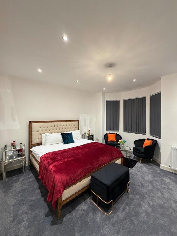 a bedroom with a large bed with a red blanket at The Central Haven in Manchester
