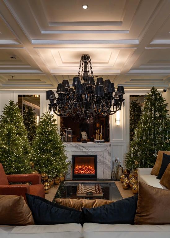 a living room with a fireplace and christmas trees at The Savile, by Harry's in Hanoi
