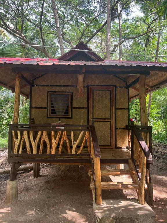 a small house with a roof on top of it at ocam ocam cottages in Busuanga