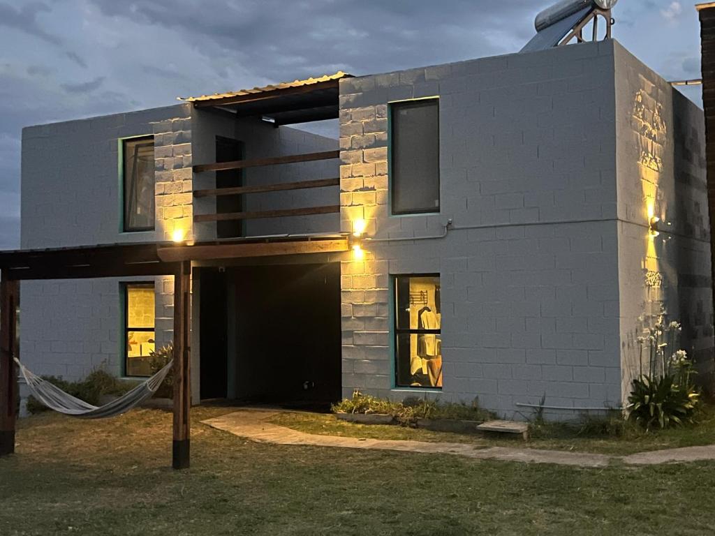 a white brick house with an open garage at Altos de Arenas in Miramar