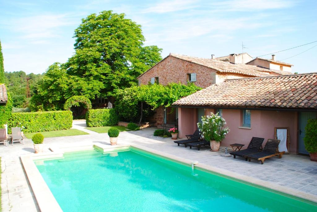 a house with a swimming pool in front of a house at B&B La Badelle in Gordes