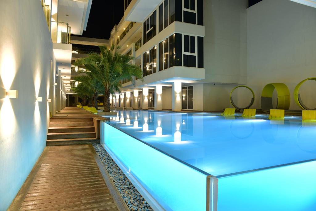 a swimming pool in a building with blue lighting at Astoria Current in Boracay