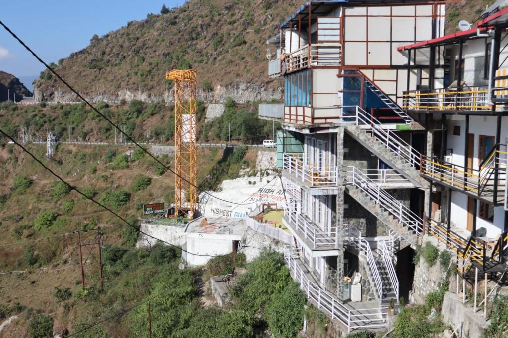 een gebouw met trappen aan de zijkant van een berg bij Misty Meadows in Mussoorie