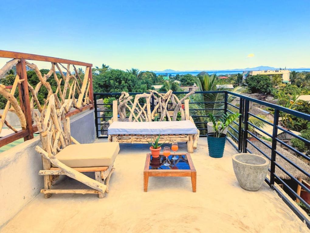 eine Terrasse mit zwei Stühlen und einem Tisch auf einem Balkon in der Unterkunft Villa Natura in Ambondrona