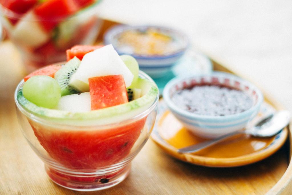 a glass cup filled with fruit and vegetables on a table at Villino Eleonora in Parghelia