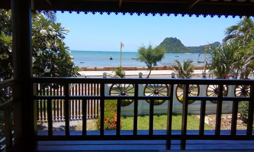 a view of the beach from the balcony of a resort at SeeSea Thai wooden house on beachfront in Prachuap Khiri Khan