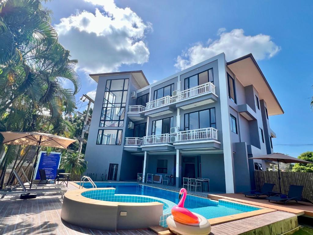 a villa with a swimming pool and a house at Serenity by Peace Garden in Amphoe Koh Samui