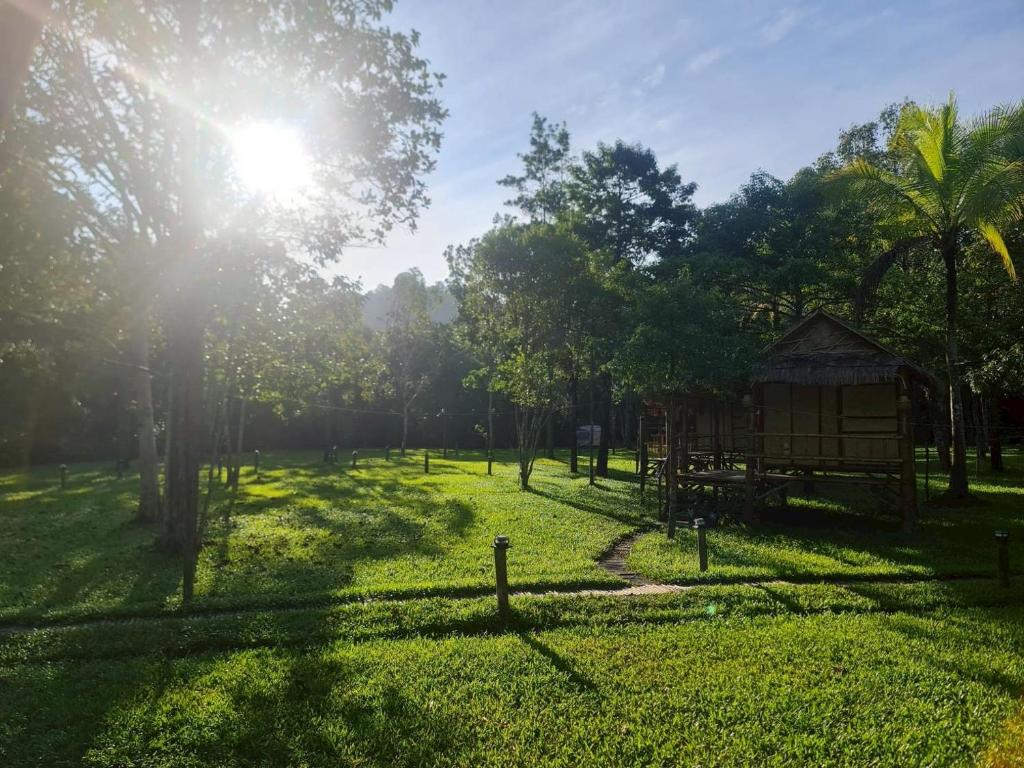 a park with a playground and the sun shining at Koh kood Good Time by Jasmine in Ko Kood