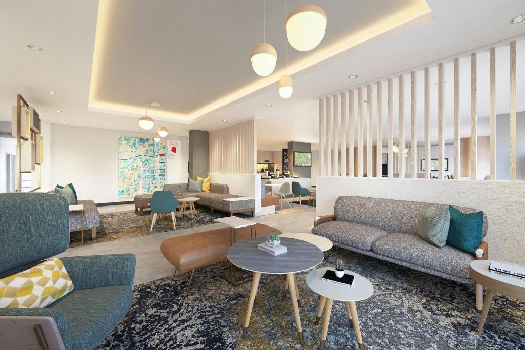 a living room with couches and tables at TownePlace Suites by Marriott Daytona Beach Oceanfront in Daytona Beach