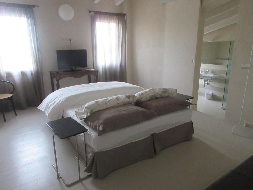 a bedroom with a bed and a couch and a television at Villa Laura in Cocconi