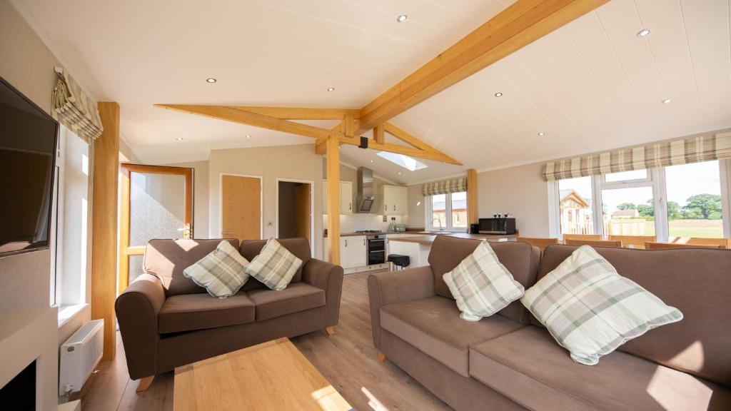 a living room with two couches and a kitchen at Primrose 2 bed-No Pets-Daisy in Horham