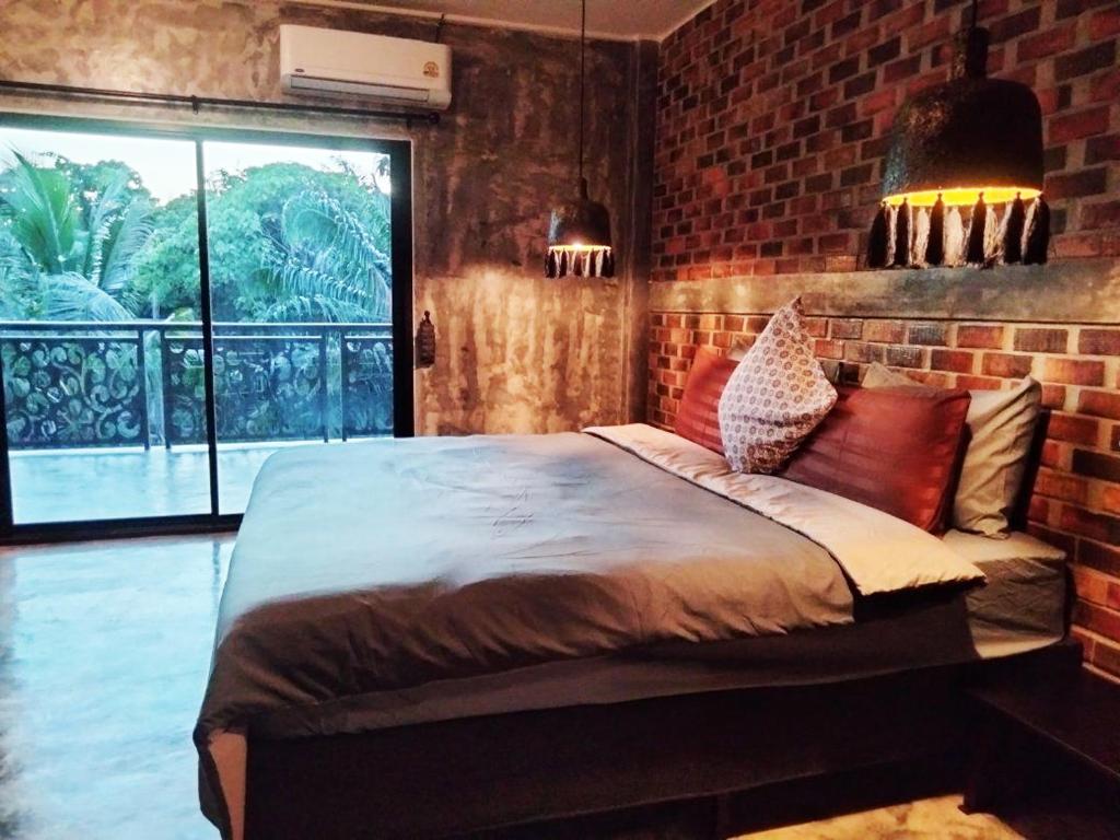 En eller flere senge i et værelse på Baan Malee Villa