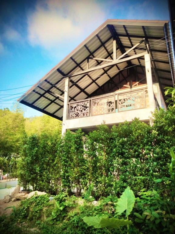 a building with a canopy over some bushes at Baan Malee Villa in Ko Lanta