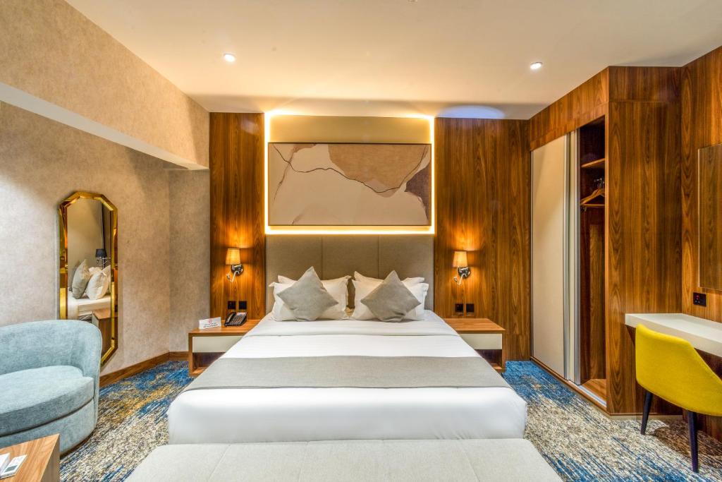 a bedroom with a large white bed in a room at Haven Plaza Olaya By Tijan Co in Riyadh