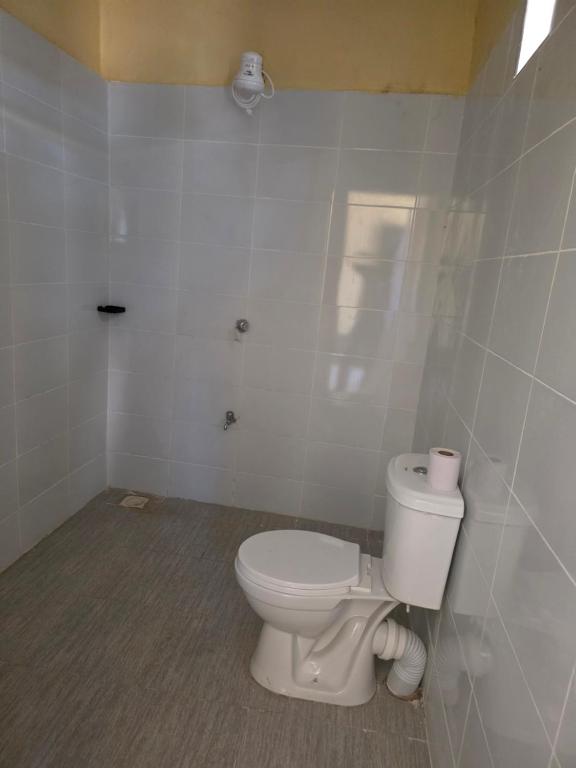 Civara Guest House في Kinancha: حمام مع مرحاض أبيض في الغرفة