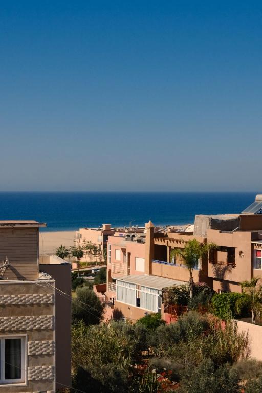 a view of the beach from a building at Catamaran Surf House in Agadir nʼ Aït Sa