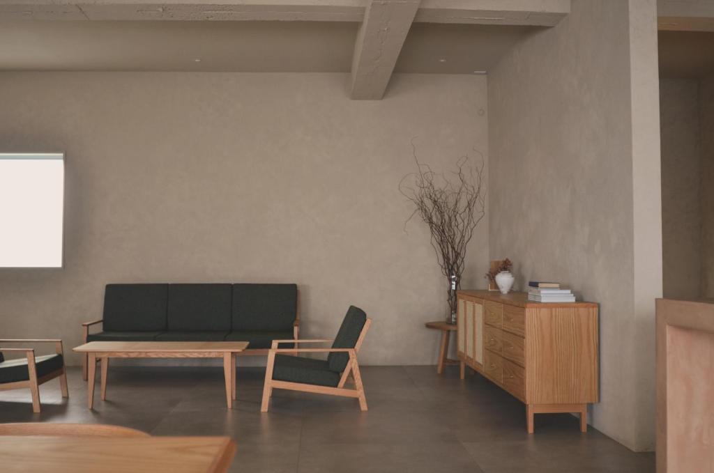 a living room with a couch and a table at 雲居月-kumoizuki- in Ginowan