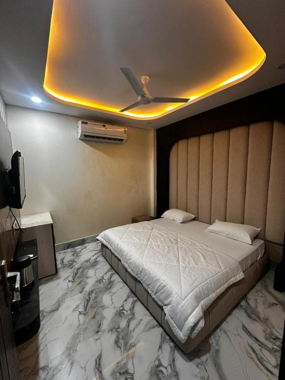 a bedroom with a large bed and a ceiling at Hotel kapil royal inn in Haridwār