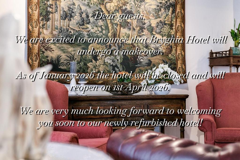 a living room with red chairs and a fireplace at Hotel Bryghia in Bruges