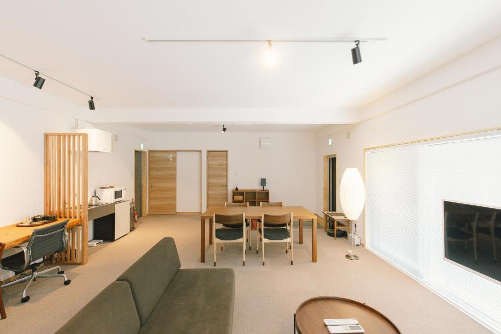 a living room with a couch and a table at Stay Okumatsusaka in Matsuzaka