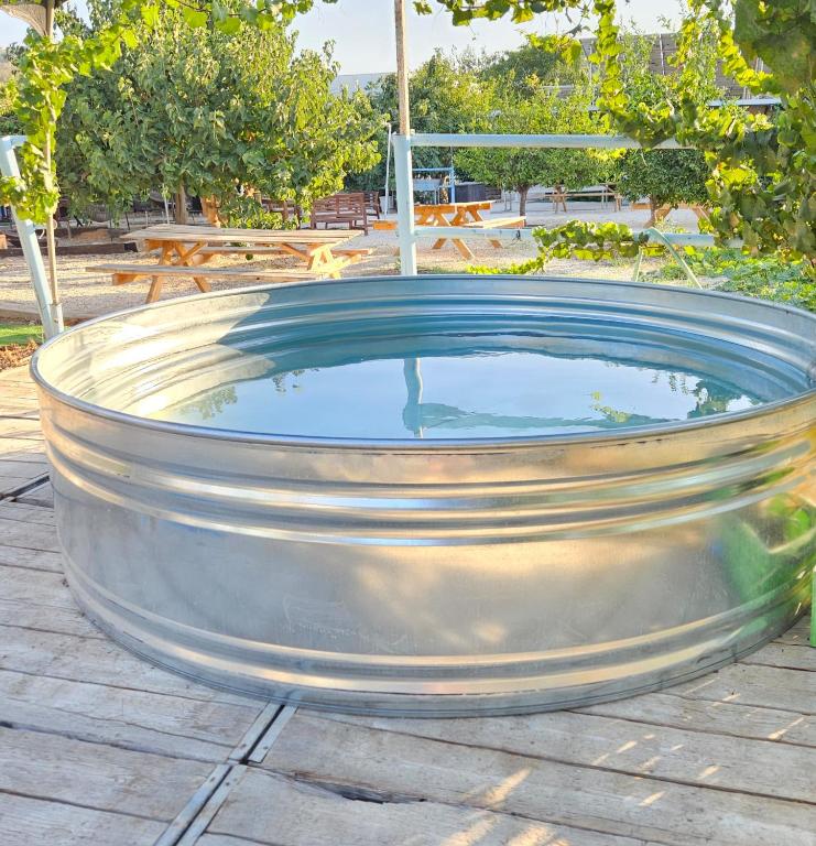 a large metal tub sitting on a patio at חאן בשביל היער in Ta‘oz