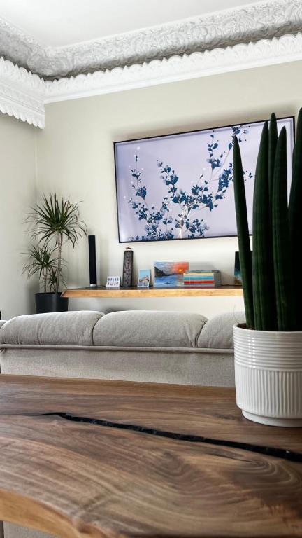 a living room with a couch and a flat screen tv at Marios House in Kini