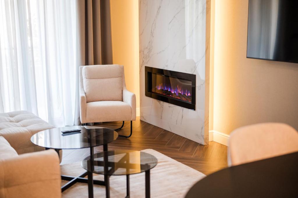 a living room with a couch and a fireplace at Ideal Apartments in Banja Luka