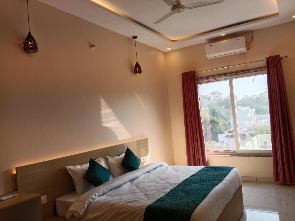 a bedroom with a bed and a window at Aamaya Inn in Haldwāni